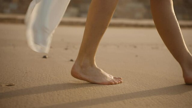 Woman walking on the beach at morning