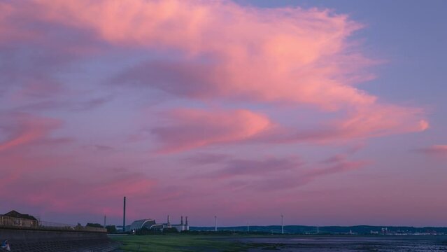 Pink sky sunset time lapse over industrial factory landscape