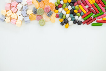 many different candies, sweets on white background