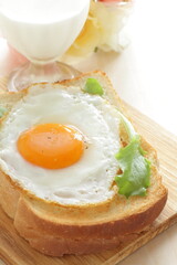 Sunny side up fried egg on toast with glass of milk  for nutritional breakfast 