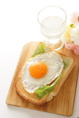 Sunny side up fried egg on toast with glass of milk  for nutritional breakfast 