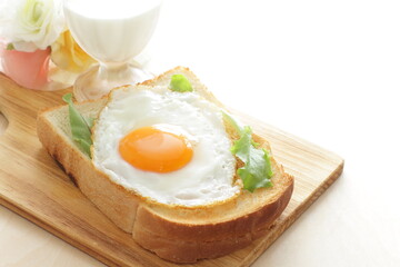 Sunny side up fried egg on toast with glass of milk  for nutritional breakfast 