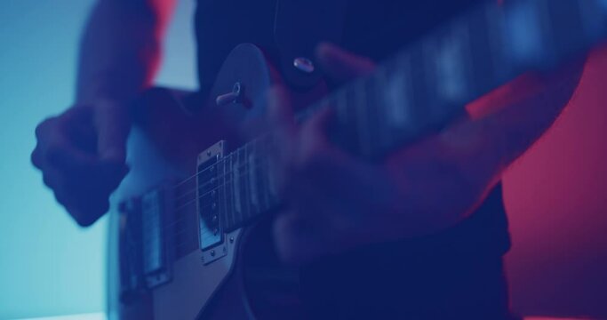 Guitarist flicking pickup switch and playing electric guitar