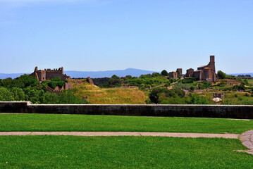the castle of the rivellino and the basilica san pietro Tuscania Italy - obrazy, fototapety, plakaty