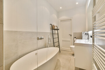 Modern home interior design of white bathroom with open bathtub and shower separated from toilet by...