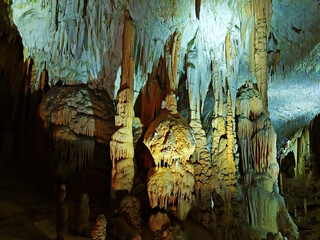 Stalactites and stalagmites in a cave. lighting. Postojna Cave, Slovenia
