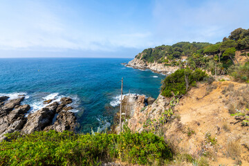 Fototapeta na wymiar View of the Mediterranean sea and coast of Costa Brava from the Cala Banys nature walk trail and gardens at the town of Lloret de Mar, Spain.