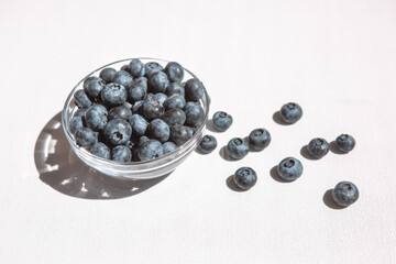Blue blueberry on white table, card with organic sweet food