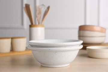 Fototapeta na wymiar Two ceramic bowls on wooden table indoors