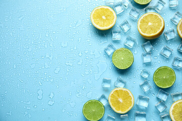 Ice cubes, cut citrus fruits and space for text on turquoise background, flat lay. Refreshing drink...
