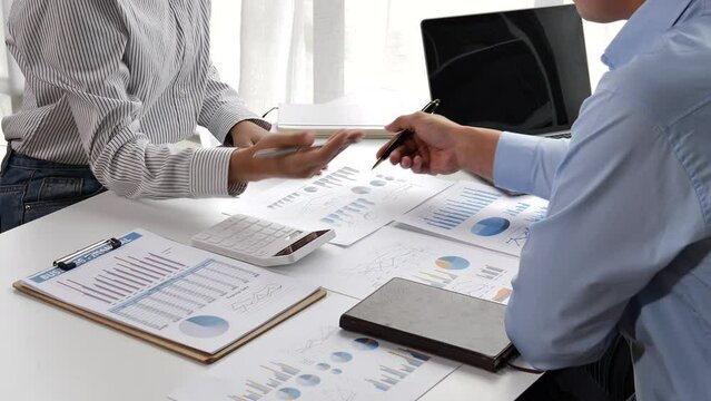 Discussing accounting people and accountant, advice brief and point hand to graph report talk to client at office desk.