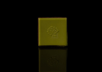 Japanese green chocolate with sakura pattern. Black background