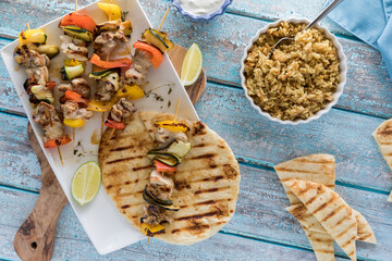 Grilled chicken and veggie shish kebabs, served with rice pilaf and naan bread.