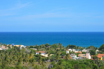 Fototapeta na wymiar Landscape of a blue ocean and green trees at Salvador