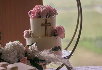 First communion cake on wooden background and empty space for text