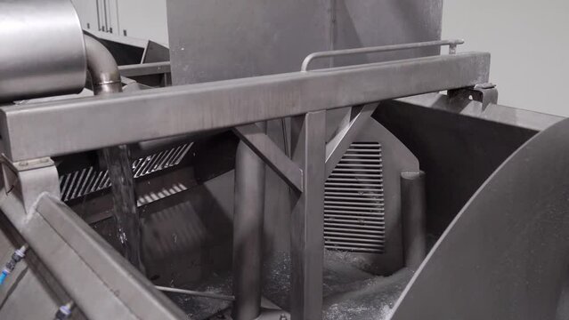 Fill cool water in an industrial chiller stainless tank for reduce temperature chicken whole.