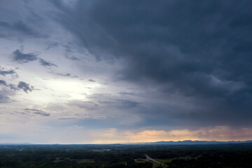 During sunset, of landscape dramatic panorama shows storm clouds in the sky
