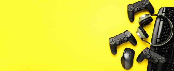 Modern gaming accessories on yellow background with space for text