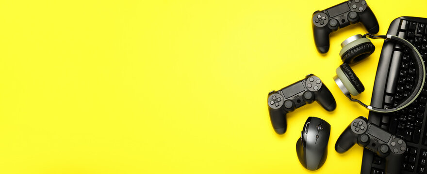Modern gaming accessories on yellow background with space for text