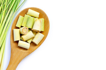 Lemongrass slices on wooden spoon on white