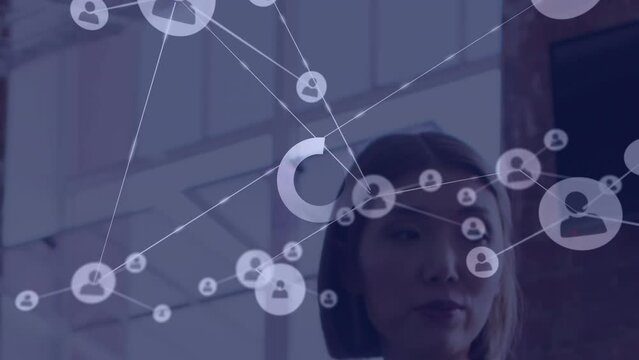 Animation of connections with digital icons over asian businesswoman in office