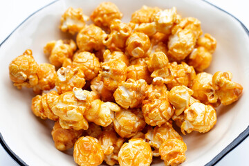 Honey caramel popcorn on white background.