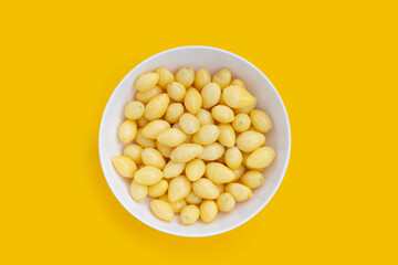 Boiled ginkgo nuts on yellow background.