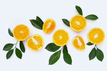 Orange fruit with green leaves on white background.