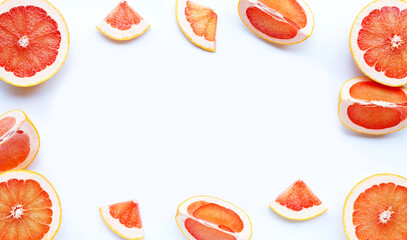 Frame made of grapefruit on white background.