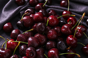Tasty cherry with water drops on napkin, closeup
