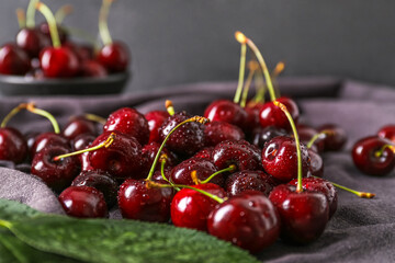 Heap of ripe cherries with water drops on table, closeup