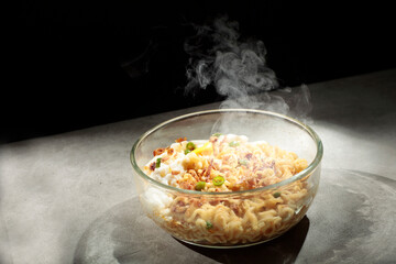 Noodles with egg toping, sprinkled with chopped green chilies and fried onions.