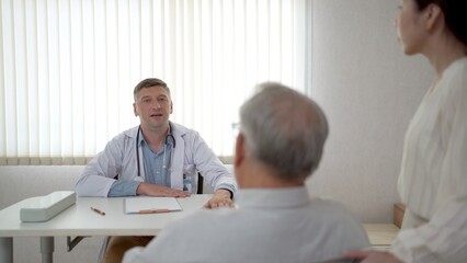 Granddaughter take her grandfather on wheelchair see the doctor or therapist at hospital. 