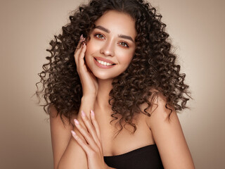 Fashion studio portrait of beautiful smiling woman with afro curls hairstyle. Fashion and beauty
