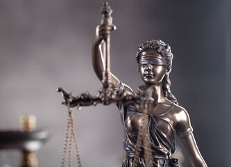 Law and justice concept. Justice symbol - Themis sculpture on gray background.