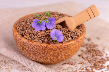 Flax seeds in a wooden bowl. Close-up.
