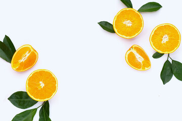 Frame made of orange fruit with green leaves on white background.