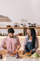 Multi-Ethnic Couple Cooking at Home