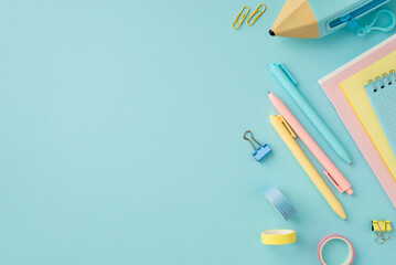 School accessories concept. Top view photo of colorful stationery copybooks pencil-case adhesive tape binder clips and pens on isolated pastel blue background with copyspace