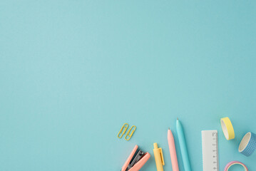 Back to school concept. Top view photo of colorful school accessories ruler adhesive tape pens clips and stapler on isolated pastel blue background with empty space