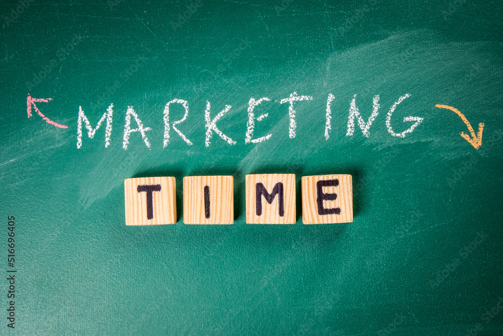 Canvas Prints marketing and time concept. text from wooden alphabet blocks on a green board
