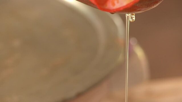 Filtering babassu vegetable oil through a clean cloth - isolated close up