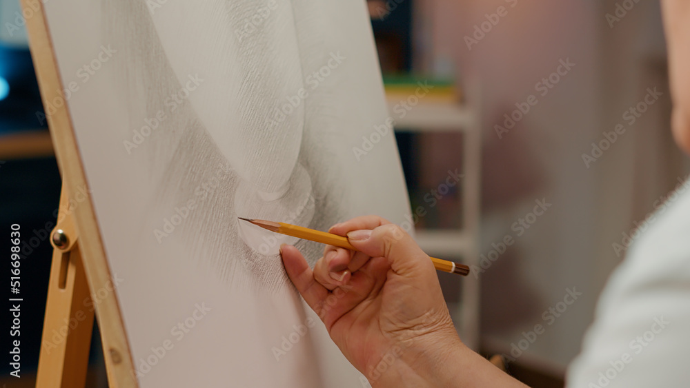 Poster hand of professional artist drawing vase model design with pencil on white canvas and wooden easel. 