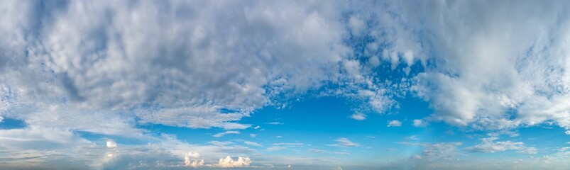 Fantastic clouds against blue sky, panorama