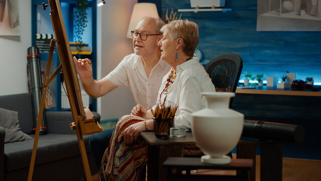 Retired man and woman doing teamwork to draw vase model with artistic skills and professional tools. Drawing artwork masterpiece with inspiration design and creativity, sketch.