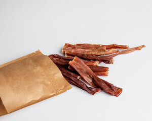 Natural dried treats for dogs. Treats for rewarding and training dogs. Dried meat products for dogs. Animal care.Selective focus. Advertisement for dog treats.