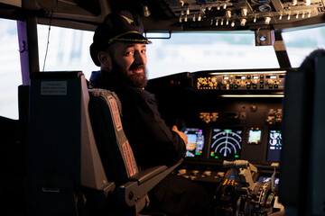 Portrait of professional aviator using cockpit dashboard command to takeoff on international...