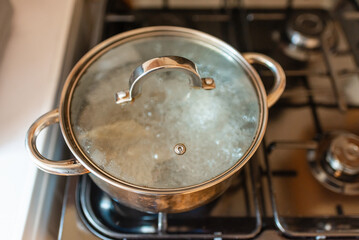 Boiling water inside a pot.Kitchen iron pot,top view,selective focus.