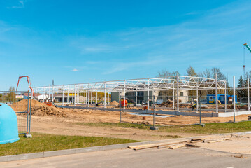 Naklejka premium Urban area with machinery, people are working on construction site.