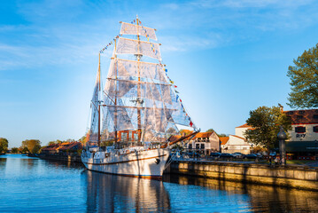 Beautiful old ship Meridian at sunset evening,blue calm sky,blue water.Symbol and landmark of...